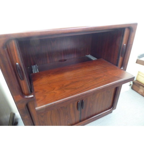 236 - A mid 20thC, possibly Dyrlund, rosewood finished media cabinet, comprising an arrangement of retract... 