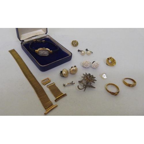 243 - Items of personal ornament: to include a lady's 9ct gold cased wristwatch; and an 18ct gold ring, se... 