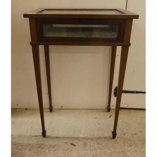 246 - An Edwardian mahogany fully glazed display table, the box top enclosed by a hinged lid, raised on sq... 