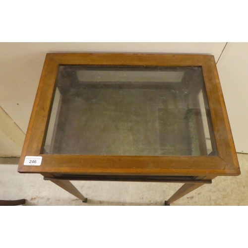 246 - An Edwardian mahogany fully glazed display table, the box top enclosed by a hinged lid, raised on sq... 