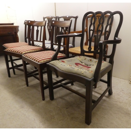 256 - Seven 19thC mahogany dining chairs: to include a pair with yoke rails and pierced splats, raised on ... 