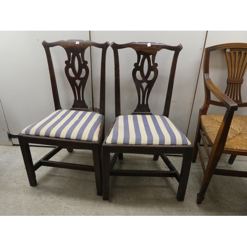 256 - Seven 19thC mahogany dining chairs: to include a pair with yoke rails and pierced splats, raised on ... 