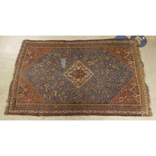 269 - A Persian rug, decorated in colours with floral and other designs  77