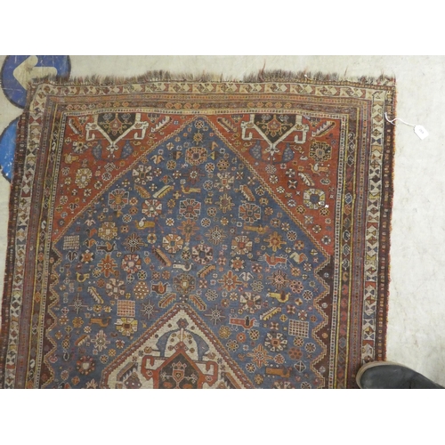 269 - A Persian rug, decorated in colours with floral and other designs  77