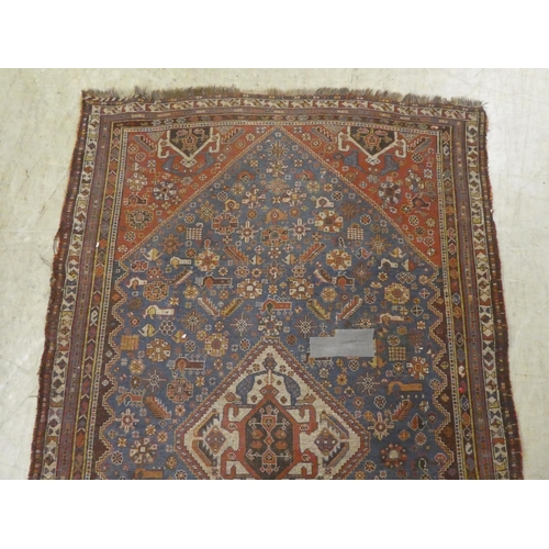 269 - A Persian rug, decorated in colours with floral and other designs  77