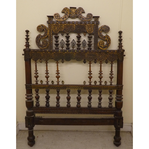 282 - A late 19thC Anglo-Indian carved hardwood and overlaid metal, single bedhead  41