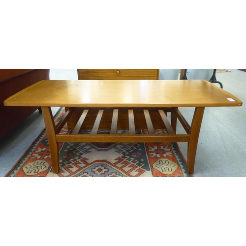 299 - Small furniture: to include a 1970/80s teak coffee table with a slatted undertier, raised on square,... 