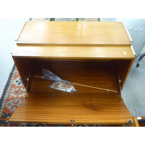 299 - Small furniture: to include a 1970/80s teak coffee table with a slatted undertier, raised on square,... 