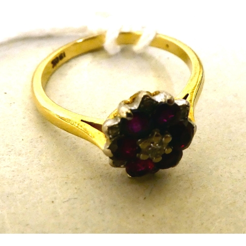 313 - A bi-coloured metal ruby and diamond cluster ring  stamped 18k