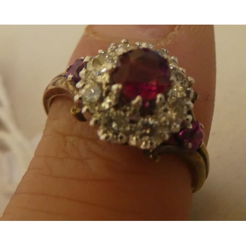 314 - A bi-coloured metal ruby and diamond cluster ring  stamped 18k