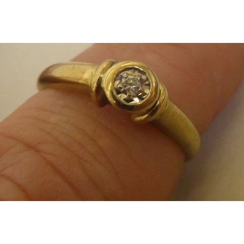 315 - A yellow metal ring, set with a single diamond  stamped 9ct 