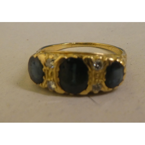 322 - A yellow metal sapphire and diamond set ring  stamped 18k