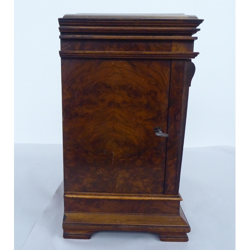 33 - An early 20thC burr walnut and mahogany cased mantel clock; the Roman dial inscribed J.Sewill of Lon... 