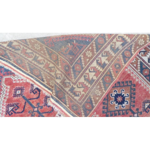 61 - A (probably) Turkish tribal Kayam stylised rug, decorated in foliage design, on a red ground  7... 