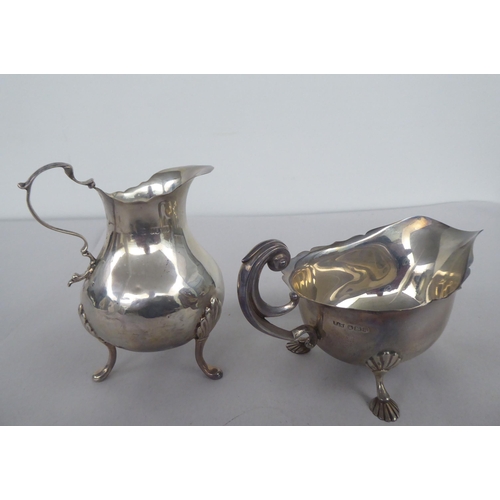 62 - Silver items, viz. a bulbous cream jug with a double C-scrolled handle; a sauce boat, elevated on sh... 