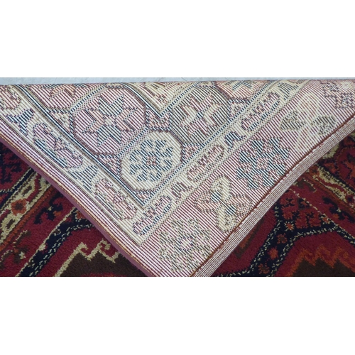 83 - A Persian design woollen carpet, decorated with repeating box design, stylised motif centre, bordere... 