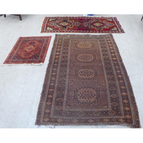 89 - Three small rugs: to include a Persian example, on a multi-coloured ground  47