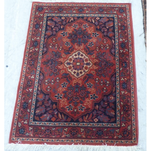 89 - Three small rugs: to include a Persian example, on a multi-coloured ground  47