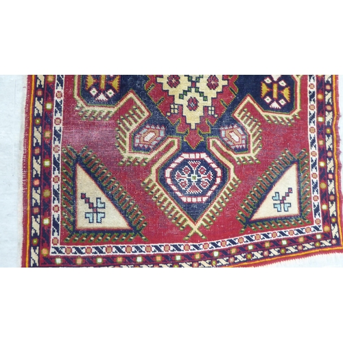 89 - Three small rugs: to include a Persian example, on a multi-coloured ground  47