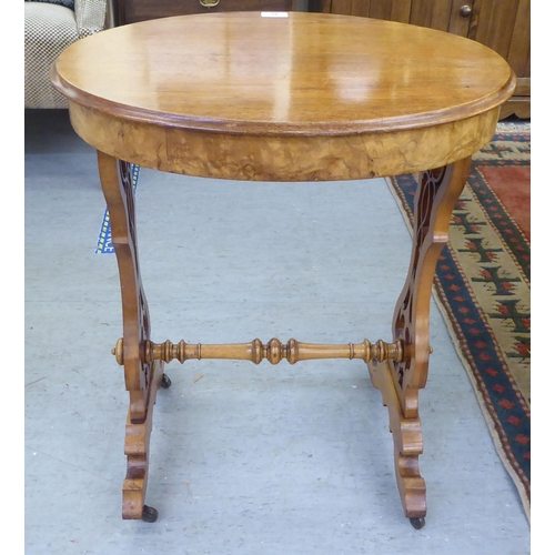 95 - A late Victorian walnut and mahogany occasional table with a shallow frieze drawer, raised on splaye... 