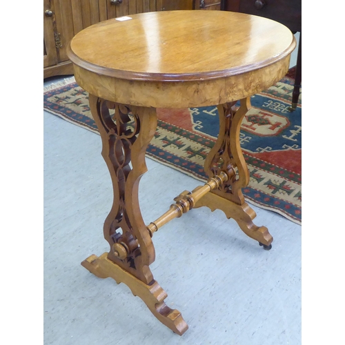 95 - A late Victorian walnut and mahogany occasional table with a shallow frieze drawer, raised on splaye... 