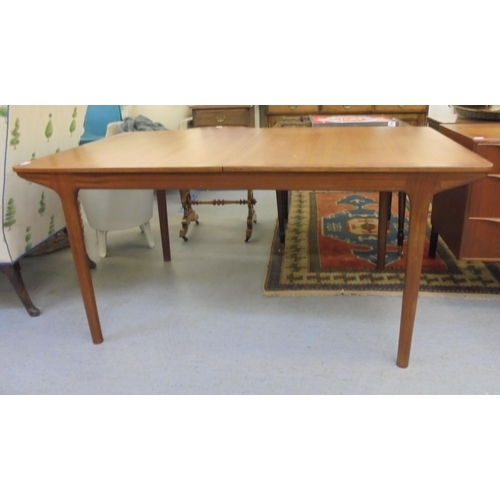 189 - A 1970s McIntosh teak draw leaf dining table, raised on round, tapered legs  29