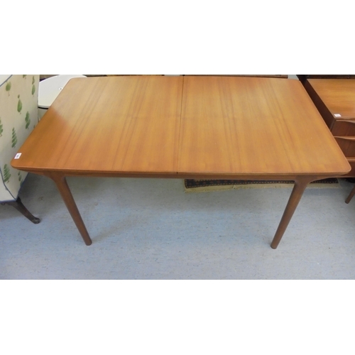 189 - A 1970s McIntosh teak draw leaf dining table, raised on round, tapered legs  29