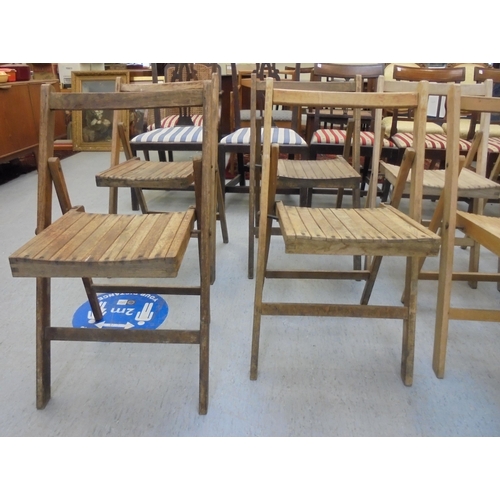 209 - A set of eight Air Ministry beech framed folding chairs, some bearing AM marks