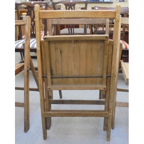 209 - A set of eight Air Ministry beech framed folding chairs, some bearing AM marks