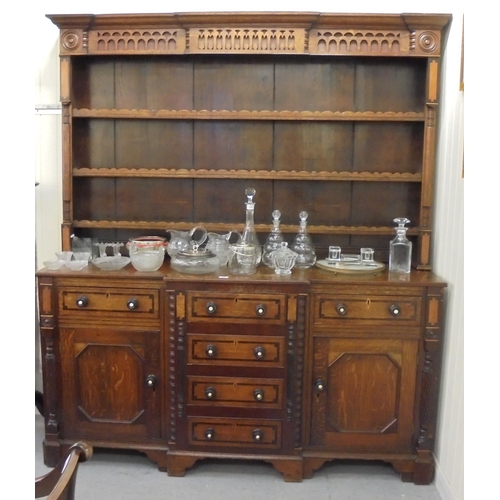 308 - A George III mahogany inlaid oak breakfront dresser with a three tier plate rack, over six drawers a... 