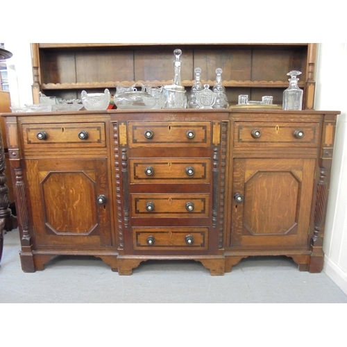 308 - A George III mahogany inlaid oak breakfront dresser with a three tier plate rack, over six drawers a... 