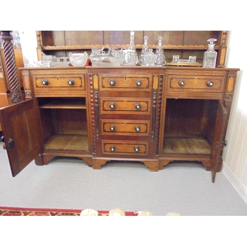 308 - A George III mahogany inlaid oak breakfront dresser with a three tier plate rack, over six drawers a... 