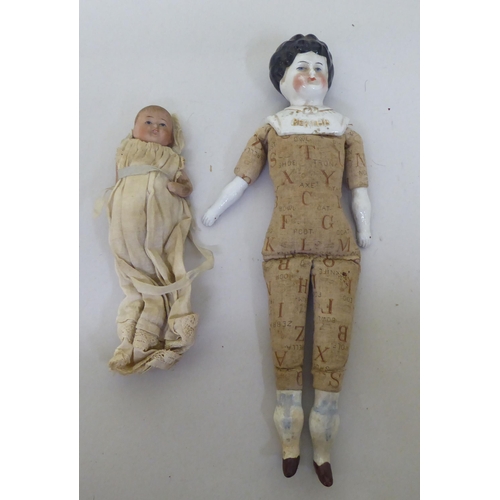 121 - Toys to include an early 20thC German bisque head doll with painted features, on a jointed compositi... 