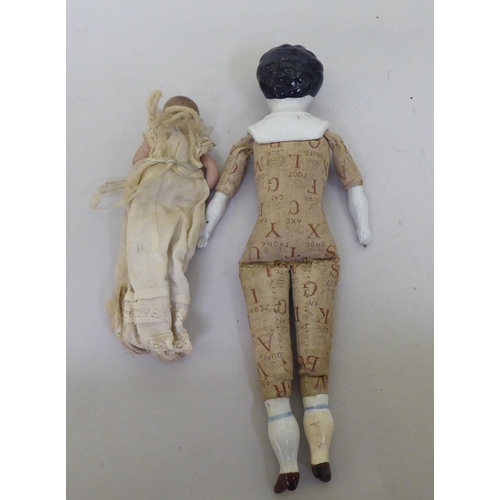 121 - Toys to include an early 20thC German bisque head doll with painted features, on a jointed compositi... 