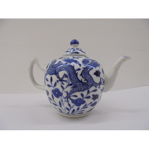 128 - Three Chinese porcelain teapots of similar form, decorated in blue and white