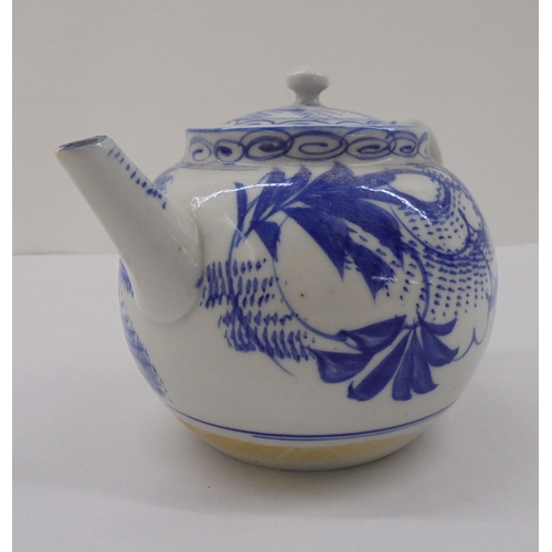 128 - Three Chinese porcelain teapots of similar form, decorated in blue and white