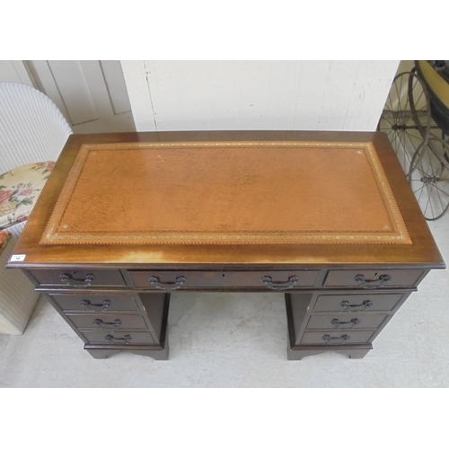 14 - A modern mahogany nine drawer twin pedestal desk, raised on bracket feet  31