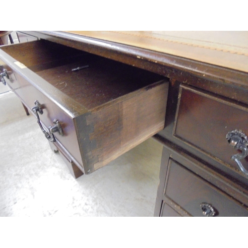 14 - A modern mahogany nine drawer twin pedestal desk, raised on bracket feet  31