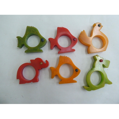 168 - A set of six childrens' novelty multi-coloured plastic napkin rings  boxed