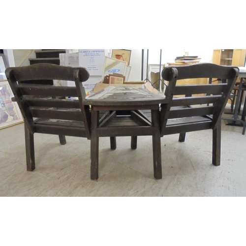 17 - A weathered teak two person conversation bench, incorporating a united centre table  61