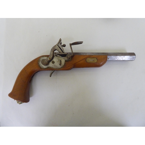 300 - A pair of replica 19thC style duelling pistols, on display plinths