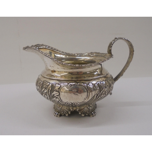 4 - A Georgian silver milk jug, cast with floral motifs  marks rubbed 