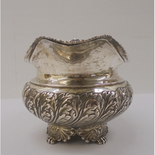 4 - A Georgian silver milk jug, cast with floral motifs  marks rubbed 