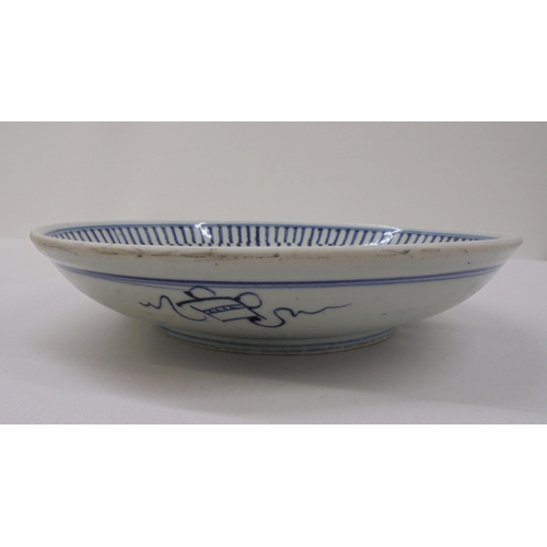 40 - A 19thC Chinese provincial footed porcelain dish, decorated in blue, brown and white with a dragon-d... 
