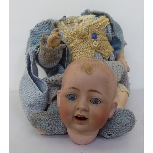 121 - Toys to include an early 20thC German bisque head doll with painted features, on a jointed compositi... 