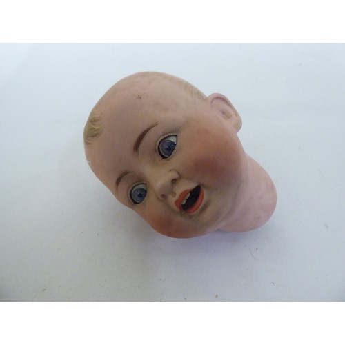 121 - Toys to include an early 20thC German bisque head doll with painted features, on a jointed compositi... 