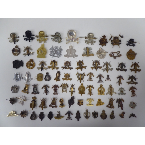 109 - Approx. sixty mainly British, regimental cap badges and associated insignia, some copies: to include... 