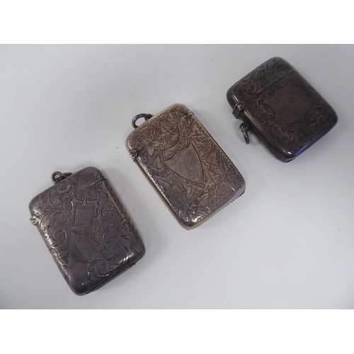 46 - Three similar late Victorian silver vesta cases of rectangular design with hinged caps, incorporatin... 