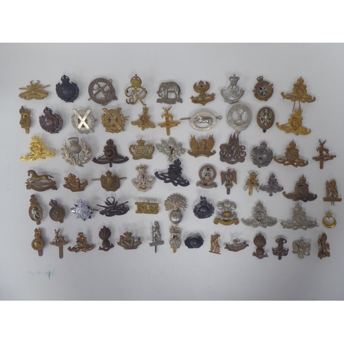 74 - Approx. sixty mainly British, regimental cap badges and associated insignia, some copies: to include... 
