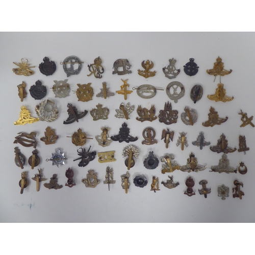74 - Approx. sixty mainly British, regimental cap badges and associated insignia, some copies: to include... 
